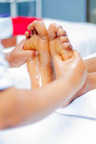 a woman is washing her feet on a table at Nefaland Hotel in Dar es Salaam
