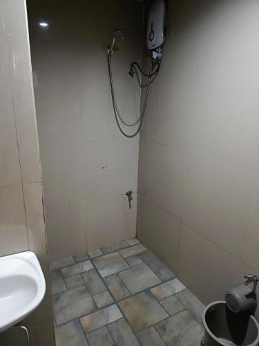a bathroom with a sink and a shower at MilVir Tourist INN in El Nido