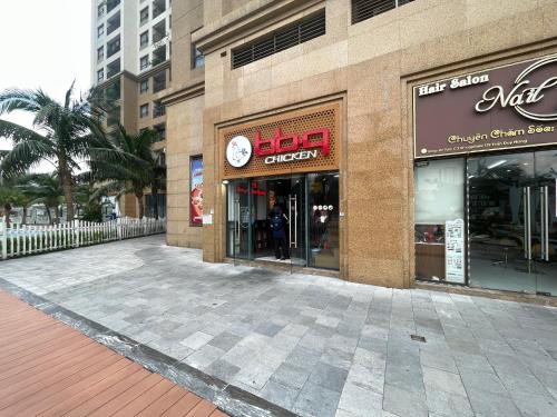 a store front of a building with a clock on it at HN ETH Vinhomes D'capitale Resident - Tran Duy Hung St in Hanoi