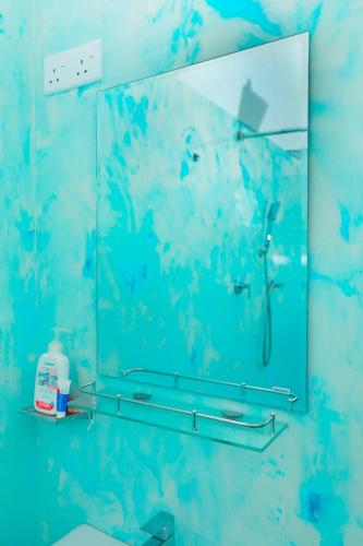 a mirror on the wall of a bathroom at Zephyr Heights in Ahangama