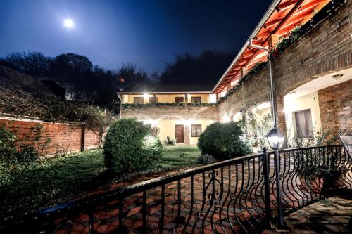a house with a fence in front of it at night at Rooms Villa Iva in Ilok