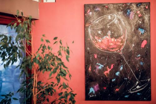 a painting of a wine glass on a wall at Rooms Villa Iva in Ilok