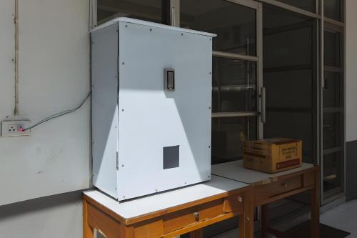 a large white appliance sitting on a wooden table at XX GO INN MAYA Chiang Mai - เมญ่า 2 in Chiang Mai