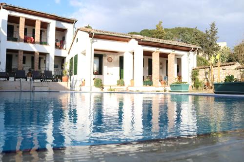 a swimming pool in front of a house at Akay Hotel in Selcuk