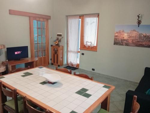 a dining room with a table and chairs and a room with at Casale del sole in Palestrina