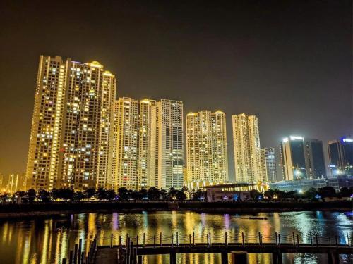 a lit up city at night with buildings at HN ETH Vinhomes D'capitale Resident - Tran Duy Hung St in Hanoi