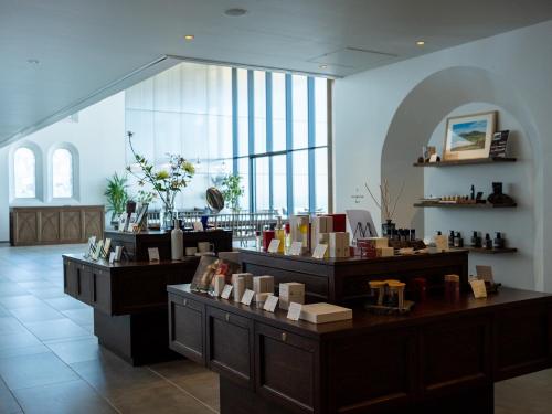 a store with two counters in a room with windows at GOTO RETREAT by Onko Chishin in Goto