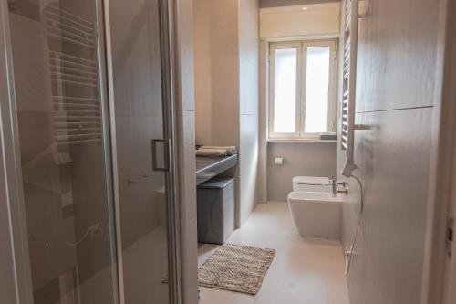 a bathroom with a shower and a toilet and a sink at A Casa di Amici in Naples