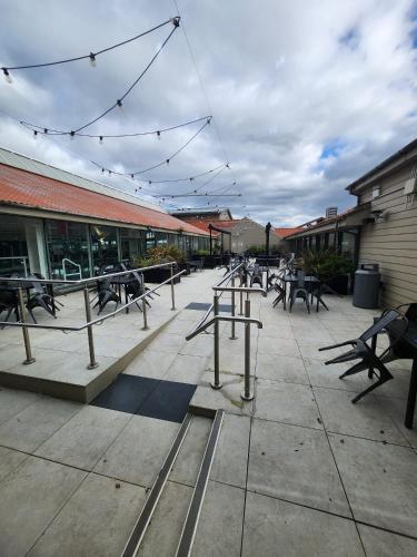 a group of tables and benches in front of a building at Seaton Sands 71 Aberlady in Port Seton