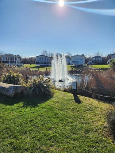 a fountain in a park with houses in the background at Seaton Sands 71 Aberlady in Port Seton