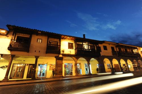 a building on the side of a street at night at El Virrey Boutique in Cusco