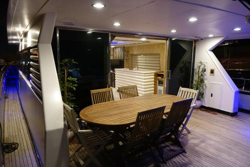 a dining room with a wooden table and chairs at Exclusive Yacht Stay - Best Sea & Old Town Views - Prime Location in Kavala