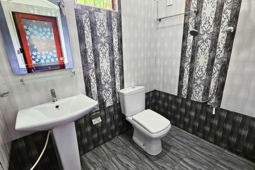 a bathroom with a toilet and a sink at Niwahana Holiday Resort in Polonnaruwa