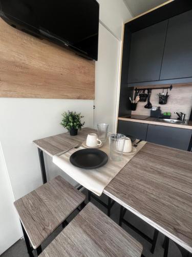 a kitchen with a table with two chairs and a sink at Mobile home Tortuga in Drage