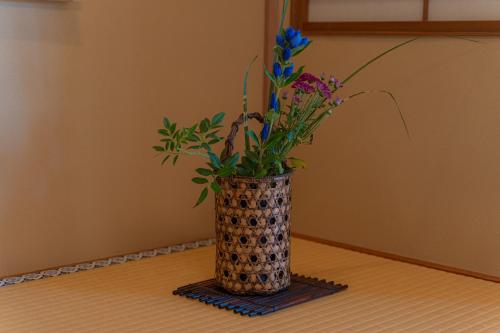 a vase with flowers in it sitting on a table at Monjusou Shourotei in Miyazu