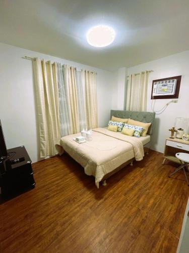 a bedroom with a bed and a table in it at Adorable Panglao Vacation House in Dauis