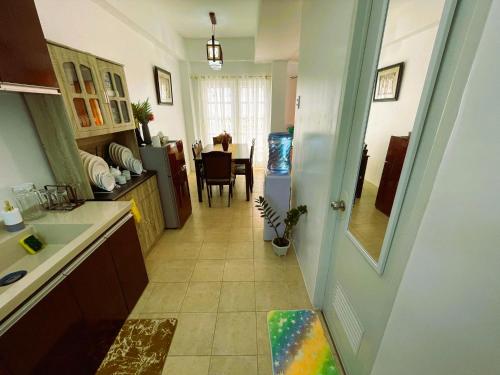 a kitchen with a hallway leading to a dining room at Adorable Panglao Vacation House in Dauis