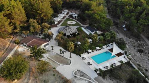 an overhead view of a mansion with a swimming pool at nature village olympos in Kumluca