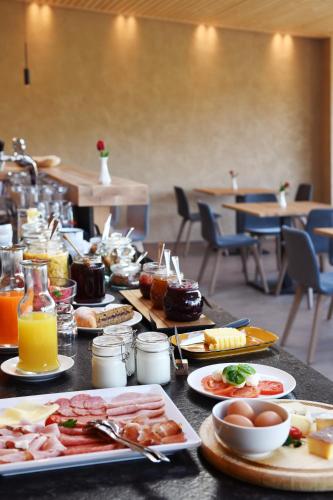 a table with many plates of food on it at Bad St Isidor in Bolzano
