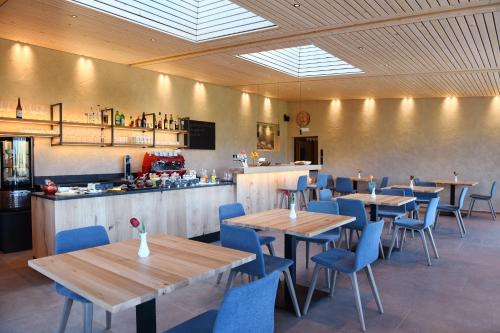a restaurant with wooden tables and chairs and a bar at Bad St Isidor in Bolzano