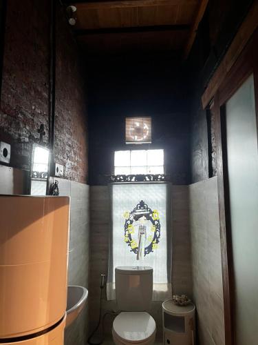 a bathroom with a toilet and a sink and a tub at 1 BR Cozy Apartment in center of Seminyak in Seminyak