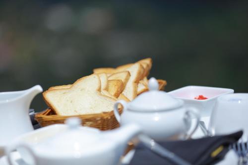 a basket of bread with a basket of toast at Villa Perpetua in Bandarawela