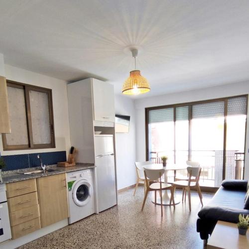 a kitchen and living room with a table and chairs at María PLAYA BRISA NG in Peniscola
