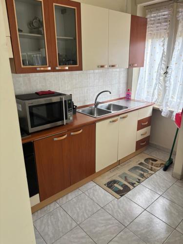 a kitchen with a sink and a microwave at GreenAppartament del lago in Viverone