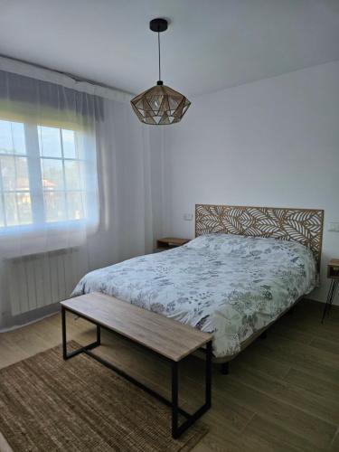 a bedroom with a bed and a table in it at El Tayo in Cudillero