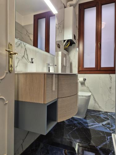 a bathroom with a sink and a toilet at Prince Apartments in Venice
