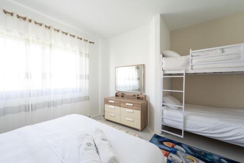 a bedroom with two bunk beds and a mirror at El Gouna - BIRD NEST in Hurghada