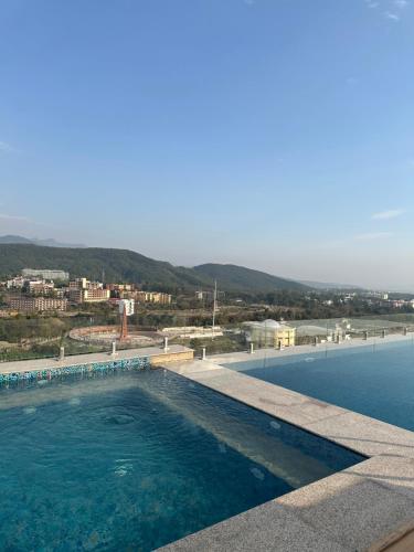 a swimming pool with a view of the water at Eden Wellness and Hospitality in Dehradun