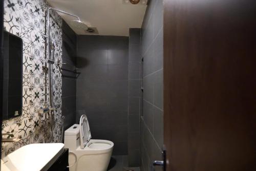 a bathroom with a toilet and a sink at Ben's Premier Hotel & Apartment - Hanoi Center in Hanoi