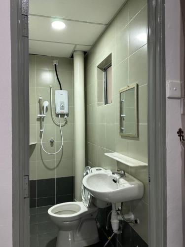 a bathroom with a shower and a toilet and a sink at Forever Green cameron in Brinchang
