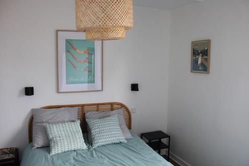 une chambre avec un lit avec deux oreillers dans l'établissement Ker Augustine Maison de pecheur 3 étoiles Clévacances, à Lancieux