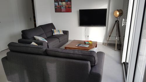 un salon avec un canapé et une table basse dans l'établissement Maison neuve 400 m des plus belles plages, à Loctudy