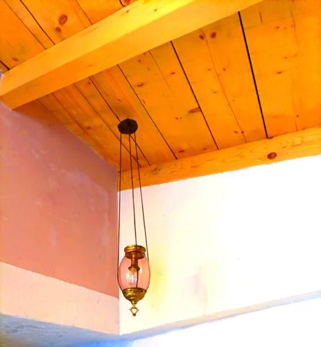 a light fixture hanging from a wooden ceiling at Home4U Κερατέα apt1, just 17Km from airport in Keratea