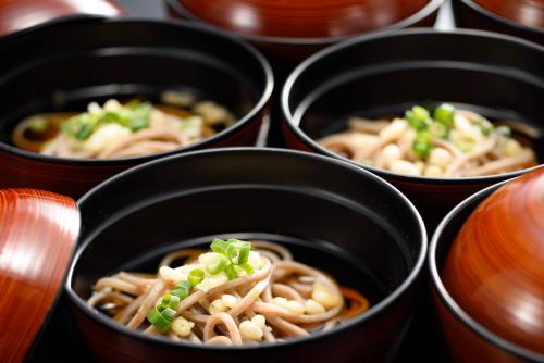 a group of black bowls filled with noodles at Hotel Royal Morioka in Morioka