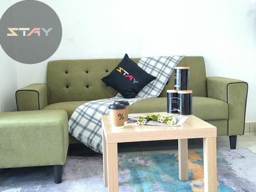 a living room with a couch and a coffee table at Almas 2Pax Cozy Serene Grey Puteri Harbour BySTAY in Iskandar Puteri