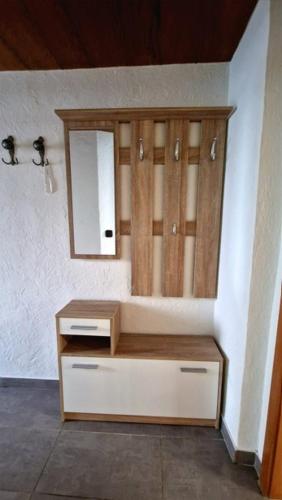 a bathroom with a dresser and a mirror on a wall at W.I.L.A. in Helmbrechts