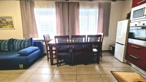 a living room with a table and chairs and a couch at W.I.L.A. in Helmbrechts
