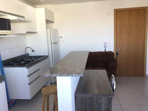 a kitchen with a sink and a counter in a room at Apto6 com WI-FI e garagem e 100 a av Brasil in Passo Fundo