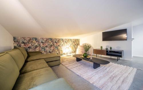 a living room with a couch and a table at L'exploratrice in Tournus