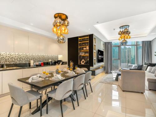 a dining room and kitchen with a table and chairs at WonderfulStay at Paramount Residences - Highest Infinity Pool - Burj Khalifa View - Brand New Luxury Apartments in Dubai