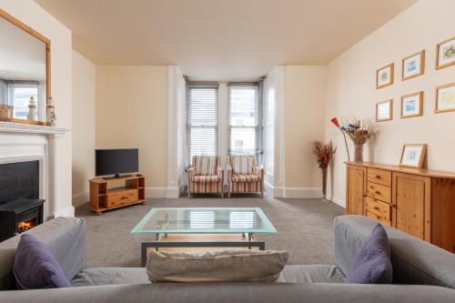 a living room with a couch and a table at Abbey Terrace - Free Parking in Whitby