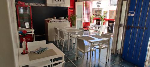 a restaurant with stools and a bar with a counter at Mecasa Hotel in Boracay