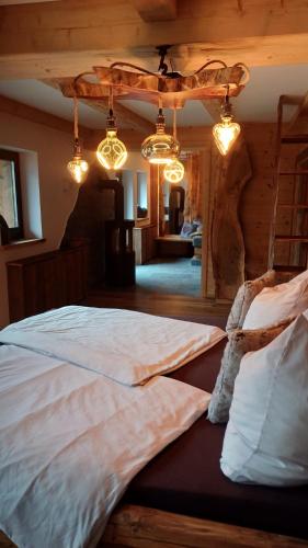 a bedroom with two beds in a room with lights at Bergromantik Ferienwohnung Harmonie in Marktschellenberg