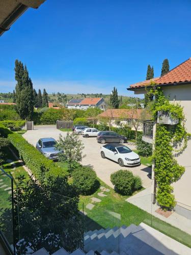 a view of a parking lot with cars parked at Apartments Aerodrom in Podgorica