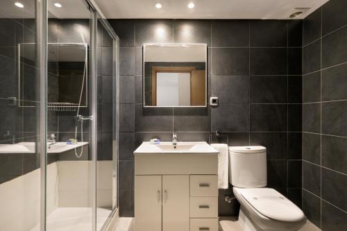 a bathroom with a toilet and a sink and a shower at SG Marina 54 Apartments in Castelldefels