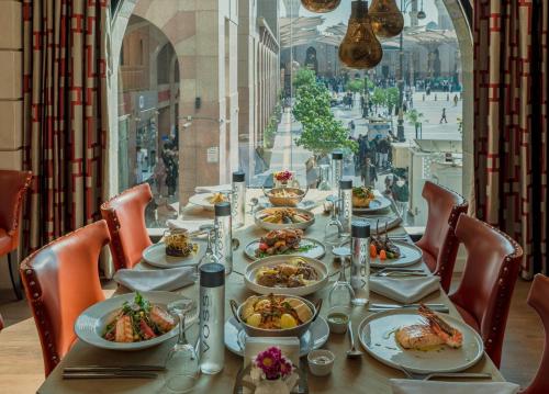 a long table with plates of food on it at Sofitel Shahd Al Madinah in Al Madinah